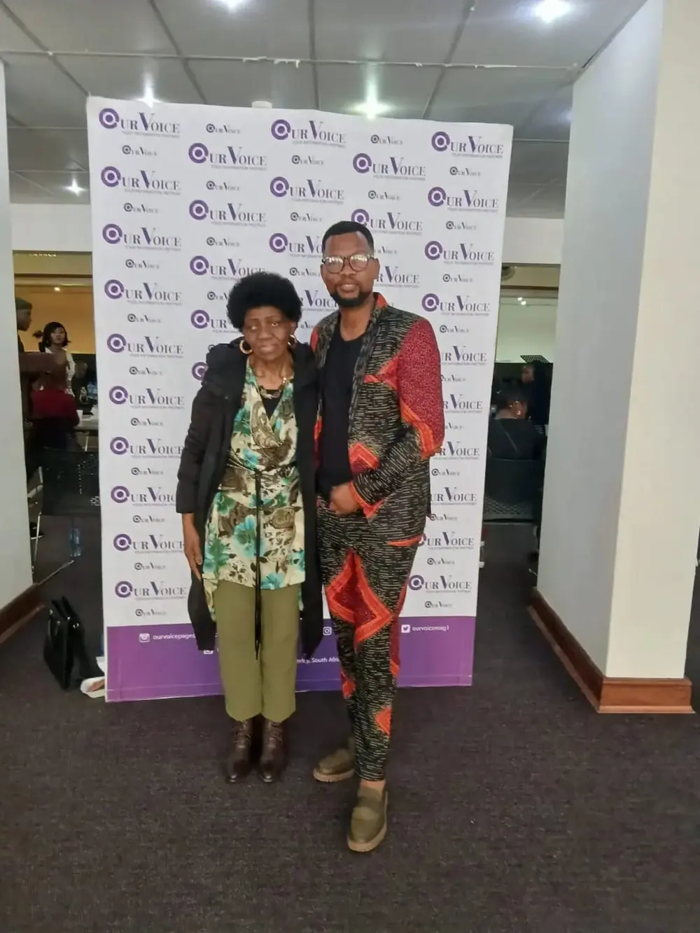Two guests at the Our Voice media wall